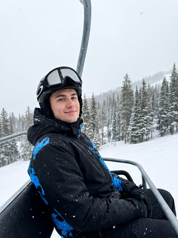 Skier wearing the KRYO jacket in Glacier Blue on a chairlift